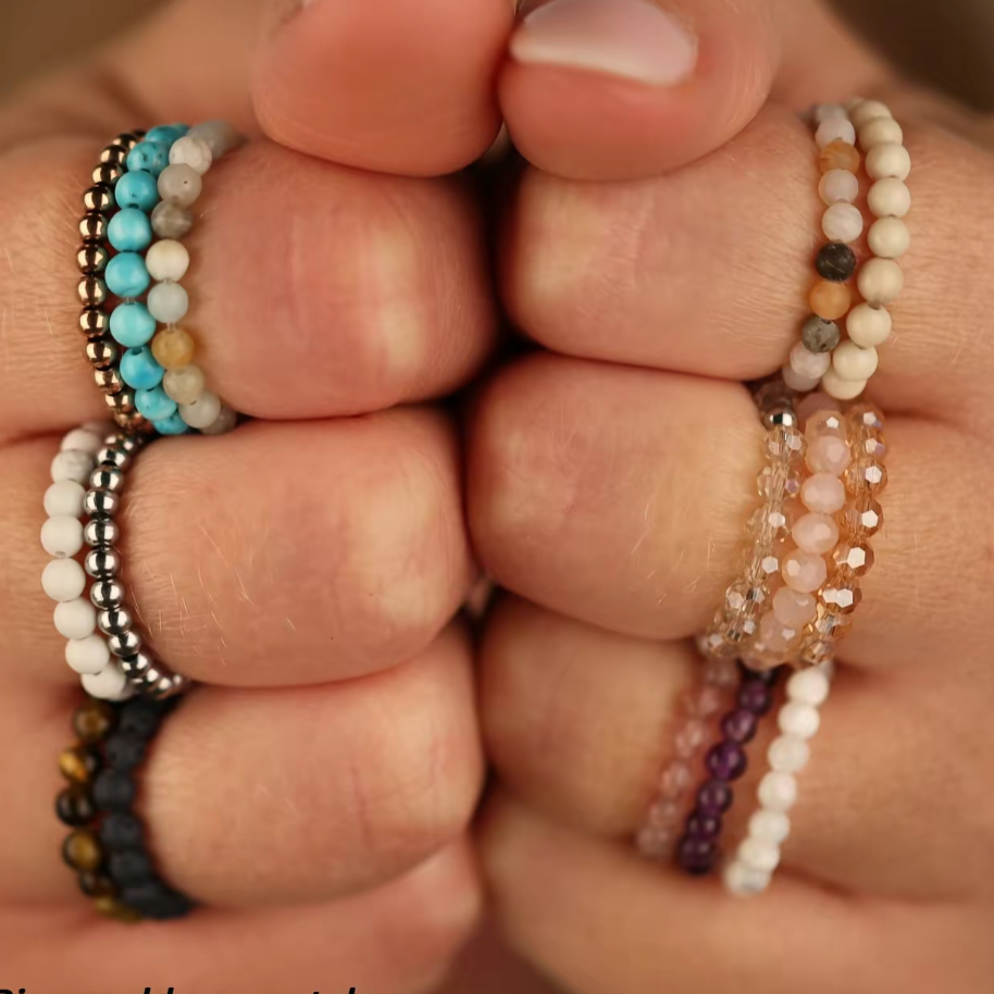Hand wearing multiple beaded gemstone rings 